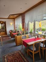 a restaurant with a table and chairs and a large window at Seehotel Andree & Gästehaus Seehof in Waldeck