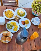 a table with plates of breakfast food on it at Residencial Brest Amazon Tarapoto in Tarapoto