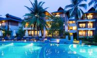 a hotel with a swimming pool in front of a building at Maehaad Bay Resort - SHA Plus in Mae Haad