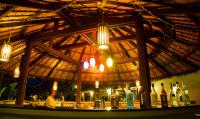 a bar in a restaurant with bottles of wine at Maehaad Bay Resort - SHA Plus in Mae Haad