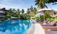 a pool at a resort with chairs and umbrellas at Maehaad Bay Resort - SHA Plus in Mae Haad