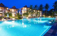 a large swimming pool in a resort at night at Maehaad Bay Resort - SHA Plus in Mae Haad