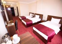 Postel nebo postele na pokoji v ubytování Resmina Hotel