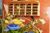 a bunch of flowers in front of a wine rack at Hôtel Le Relais in Fleurance