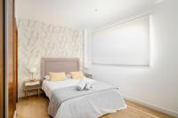 A bed or beds in a room at Apartamentos Pedregalejo Beach Playa