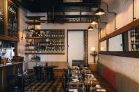 a restaurant with tables and chairs and a bar at Sophia Hotel By OxoHotel in Cartagena de Indias