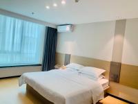 M Hotel Xiamen Haicang Maqing Road Metro Stationにあるベッド