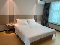 M Hotel Xiamen Haicang Maqing Road Metro Stationにあるベッド