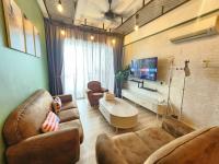 a living room with two leather couches and a tv at The Majestic Imperial Tower Premium Suite - Ipoh in Ipoh