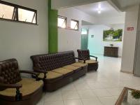 a waiting room with two chairs and a couch at Hotel Olivier in Três Rios