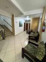 a waiting room with chairs and stairs in a building at Hotel Olivier in Três Rios