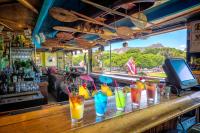 a bar with a bunch of drinks on a counter at Castle at Waikīkī Grand in Honolulu
