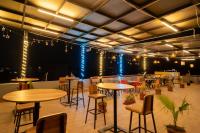 a large room with tables and chairs and lights at Majestic Hotel and Restro in Udaipur