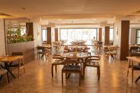 a restaurant with tables and chairs in a room at Ramada by Wyndham Dalaman in Dalaman