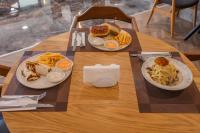 a wooden table with two plates of food on it at Ramada by Wyndham Dalaman in Dalaman