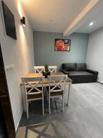 a living room with a table and chairs and a couch at Skiathos Holiday Resort in Skiathos