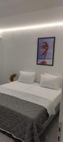 a bedroom with two beds and a picture on the wall at Skiathos Holiday Resort in Skiathos