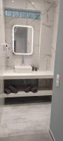 a bathroom with a sink and a mirror at Skiathos Holiday Resort in Skiathos