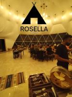 a man standing next to a table in a restaurant at Rosella Camp Wadi Rum in Disah