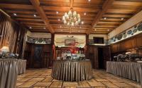 a banquet hall with a chandelier and tables at Shanghai Moller Villa Hotel - National Historic and Cultural Relics Protection Building in Shanghai