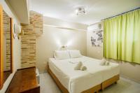 Postel nebo postele na pokoji v ubytování Rose Club Apartments