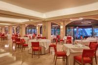 a dining room with white tables and red chairs at Secrets Mallorca Villamil Resort & Spa - Adults Only (+18) in Paguera
