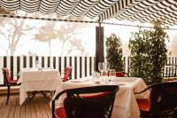 a restaurant with two tables with wine glasses on it at Secrets Mallorca Villamil Resort & Spa - Adults Only (+18) in Paguera