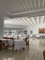 a dining room with white tables and chairs in a room at Blumar Resort & Spa in Hammamet