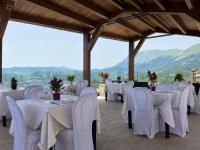 ein Bankettsaal mit weißen Tischen und Stühlen und Bergen in der Unterkunft Monti Azzurri in Montemonaco