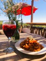 a plate of pasta and a glass of wine on a table at Hotel Quinto Sol in Mazunte