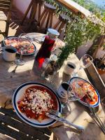 a table with plates of food and wine glasses at Hotel Quinto Sol in Mazunte