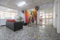 an office with a lobby with couches and a mural at Hotel Stil Cartagena in Cartagena de Indias