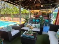 a patio with couches and a pool and a table at Hidden Gem Barbados in Christ Church
