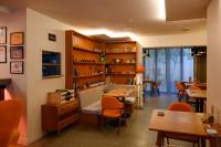 a room with wooden shelves and a table and chairs at Ohtel Auckland in Auckland