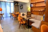 a restaurant with a dining room with tables and chairs at Ohtel Auckland in Auckland