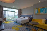 a hotel room with a bed and a couch at Chatrium Hotel Riverside Bangkok in Bangkok