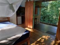 a bedroom with a bed and a large window at Jungle Paunch in Bocas del Toro