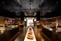 a restaurant with several tables with plates of food at Conrad Seoul in Seoul