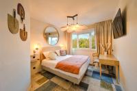 a bedroom with a bed and a desk and a mirror at BHOMA Bourges - Hôtel in Bourges