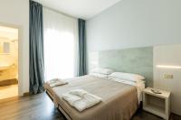 Posteľ alebo postele v izbe v ubytovaní Hotel Kim