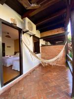a room with a hammock in the middle of a building at Hotel Pousada Marambaia in Arraial d'Ajuda
