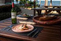 Seiri del Mar في هوبكنز: طاولة مع طبق من الطعام وزجاجة من النبيذ