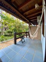 a porch with a hammock and a swing at Hotel Pousada Marambaia in Arraial d'Ajuda