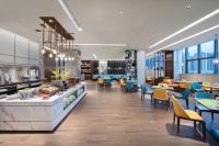 a rendering of a restaurant with tables and chairs at 南宁安吉希尔顿欢朋酒店 in Nanning