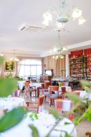 a dining room with tables and chairs and chandeliers at Hotel Ciutat Jardi in Palma de Mallorca