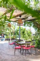 a group of tables and chairs under an umbrella at Hotel Ciutat Jardi in Palma de Mallorca