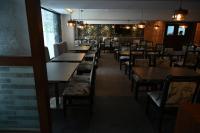 a row of tables and chairs in a restaurant at The Budhil Park in Visakhapatnam