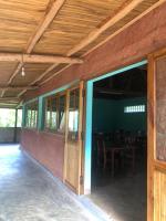 an open door of a building with a table and chairs at Soanala in Moramanga