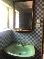 a bathroom with a sink and a mirror at Soanala in Moramanga