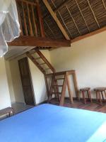a room with a ladder and two chairs and a table at Soanala in Moramanga
